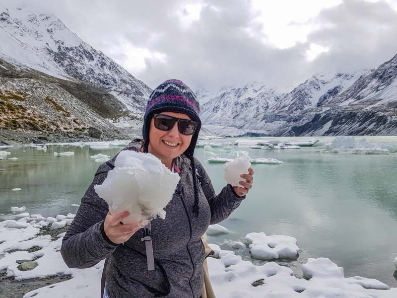 Chris Fry/Aquarius Traveller holding a small iceberg from Hooker Lake in Mount Cook National Park on the South Island of New Zealand
