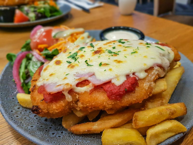chicken parmigiana with salad and chips