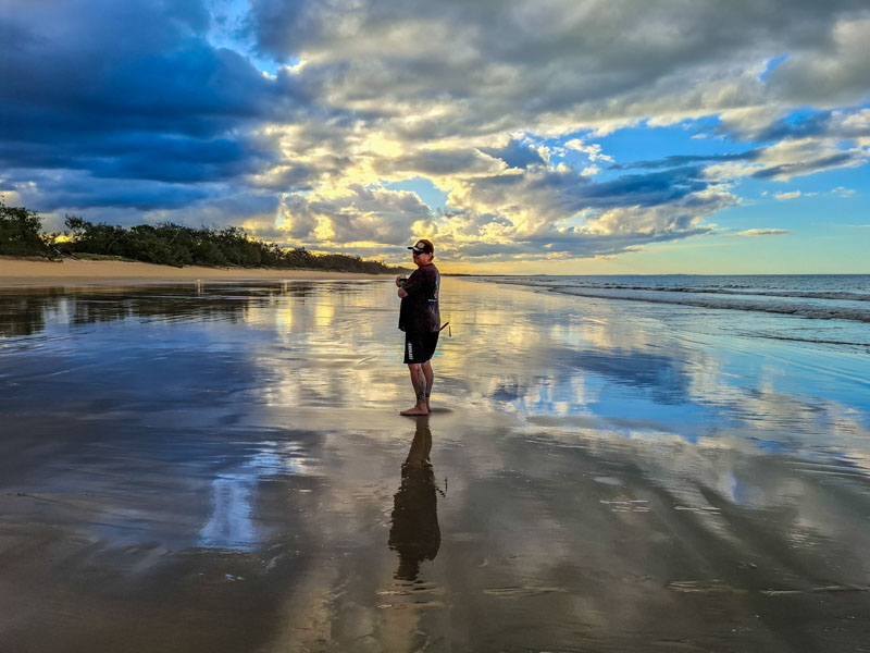 Matts reflection on the low tides waters on the beach watching sunset