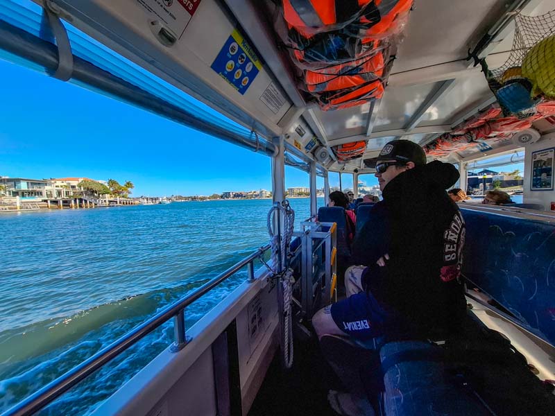 Matt looking at the Mooloola river houses while on the Aquaduck boat