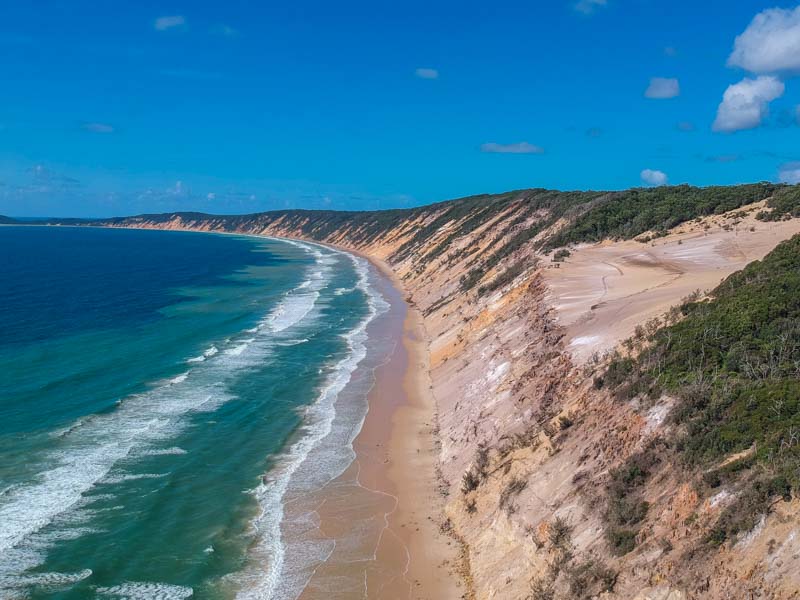 aerial view of Rainbow Beach coastline with the coloured sand cliffs