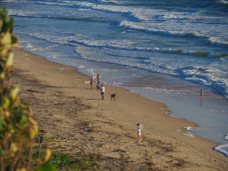 people strolling the shores at Rainbow Beach
